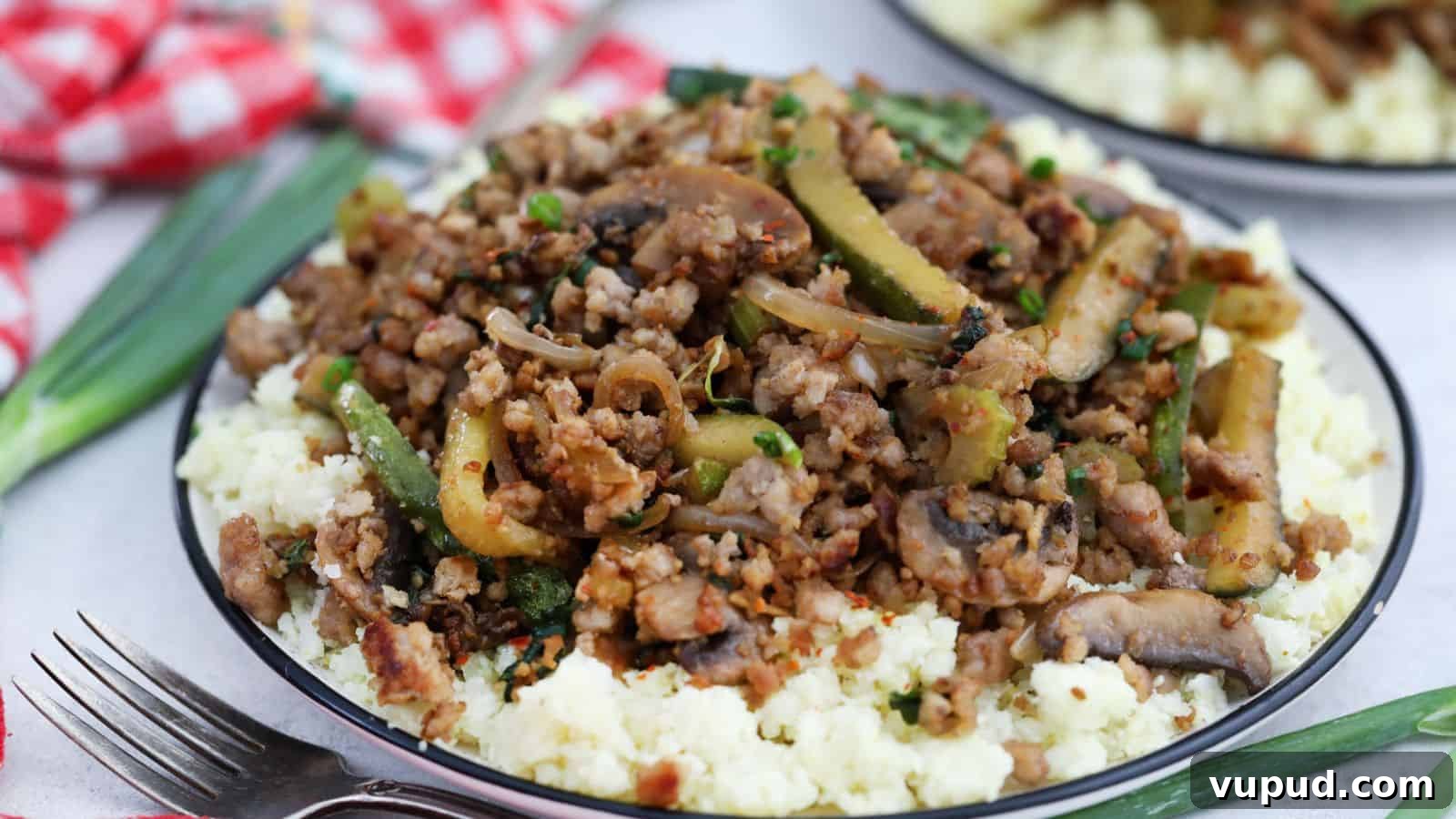 30 Flavorful Low-Carb Main Dishes That Feel Like Real Meals 4 A plate with ground pork and vegetables on top of cauliflower rice.
