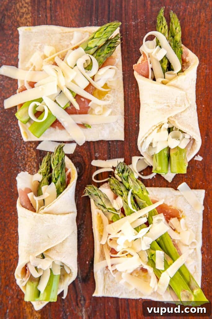 Prosciutto and Asparagus Puff Pastries for Entertaining 3 4 puff pastry squares topped with proscuitto asparagus and cheese