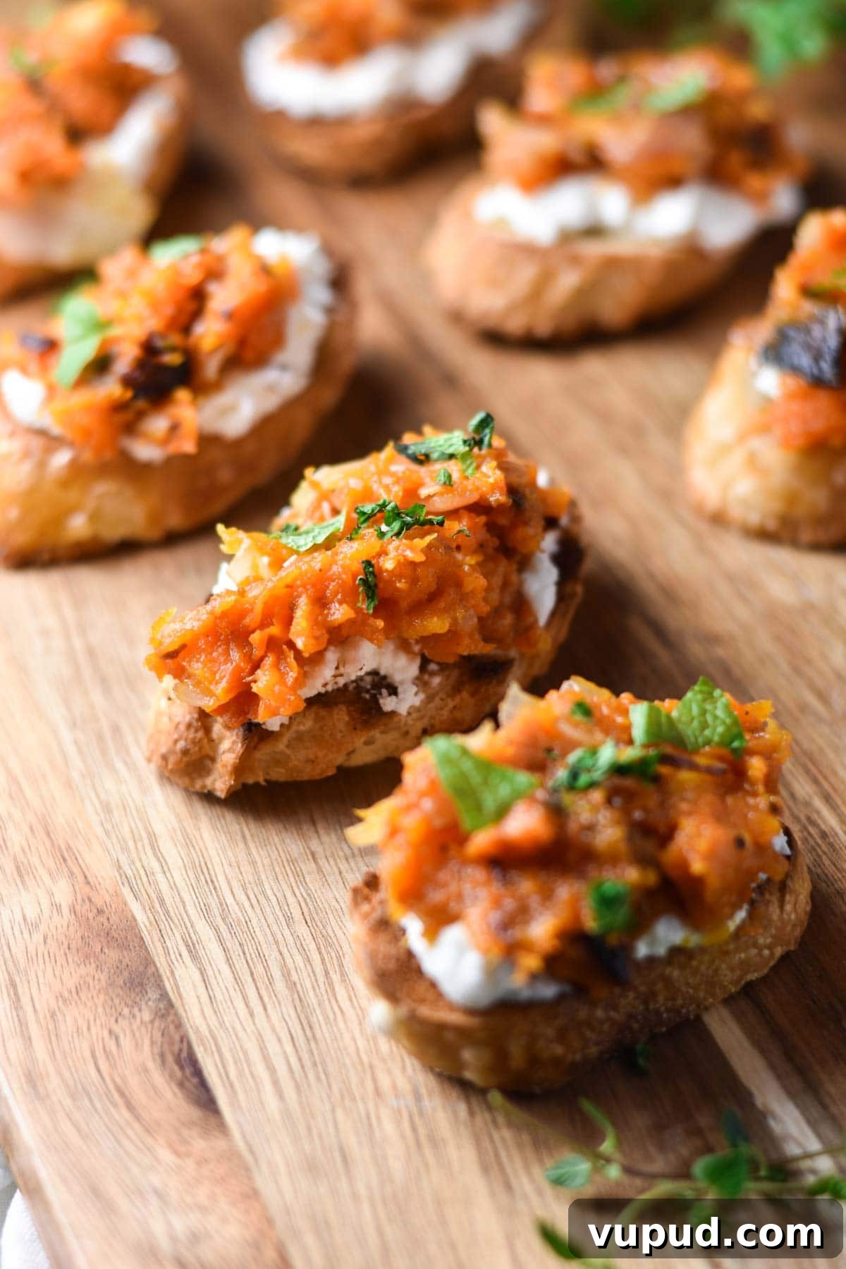 Butternut Squash Crostini with Goat Cheese and Sage 9 Placing fresh herbs on top of crostini.