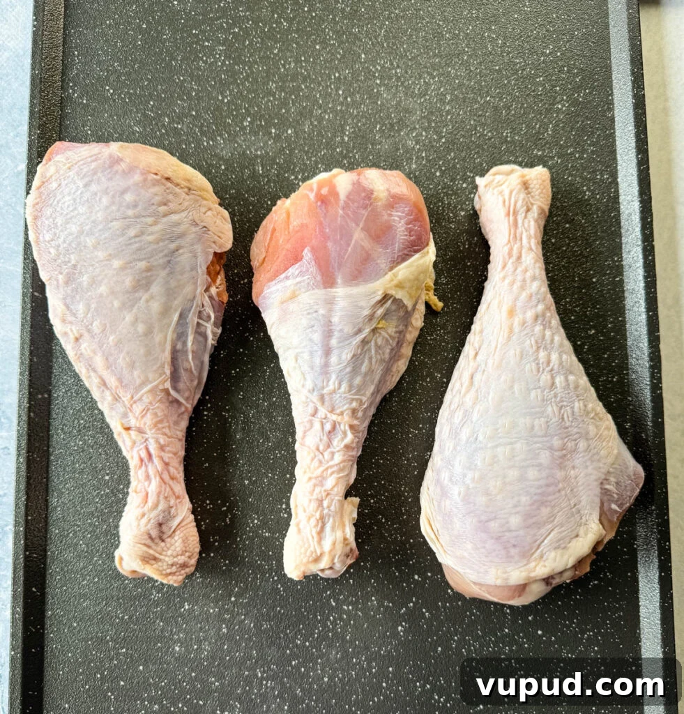 Smoky Traeger Turkey Legs Recipe: Juicy Wood-Fired Flavor 3 raw turkey legs on a sheet pan