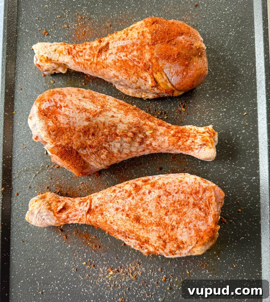 Smoky Traeger Turkey Legs Recipe: Juicy Wood-Fired Flavor 7 seasoned, raw turkey legs on a sheet pan