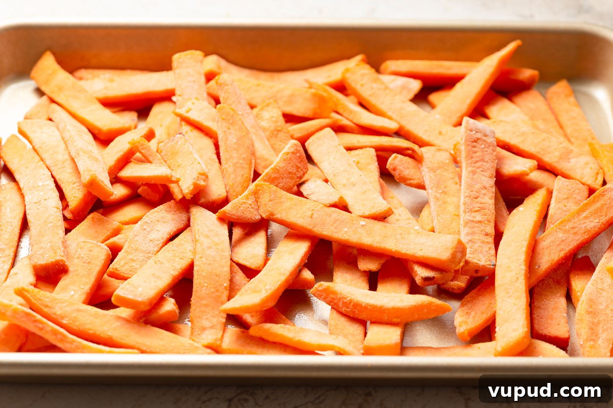 Crispy Air Fryer Frozen Sweet Potato Fries in Minutes 3 frozen sweet potato fries on a baking sheet