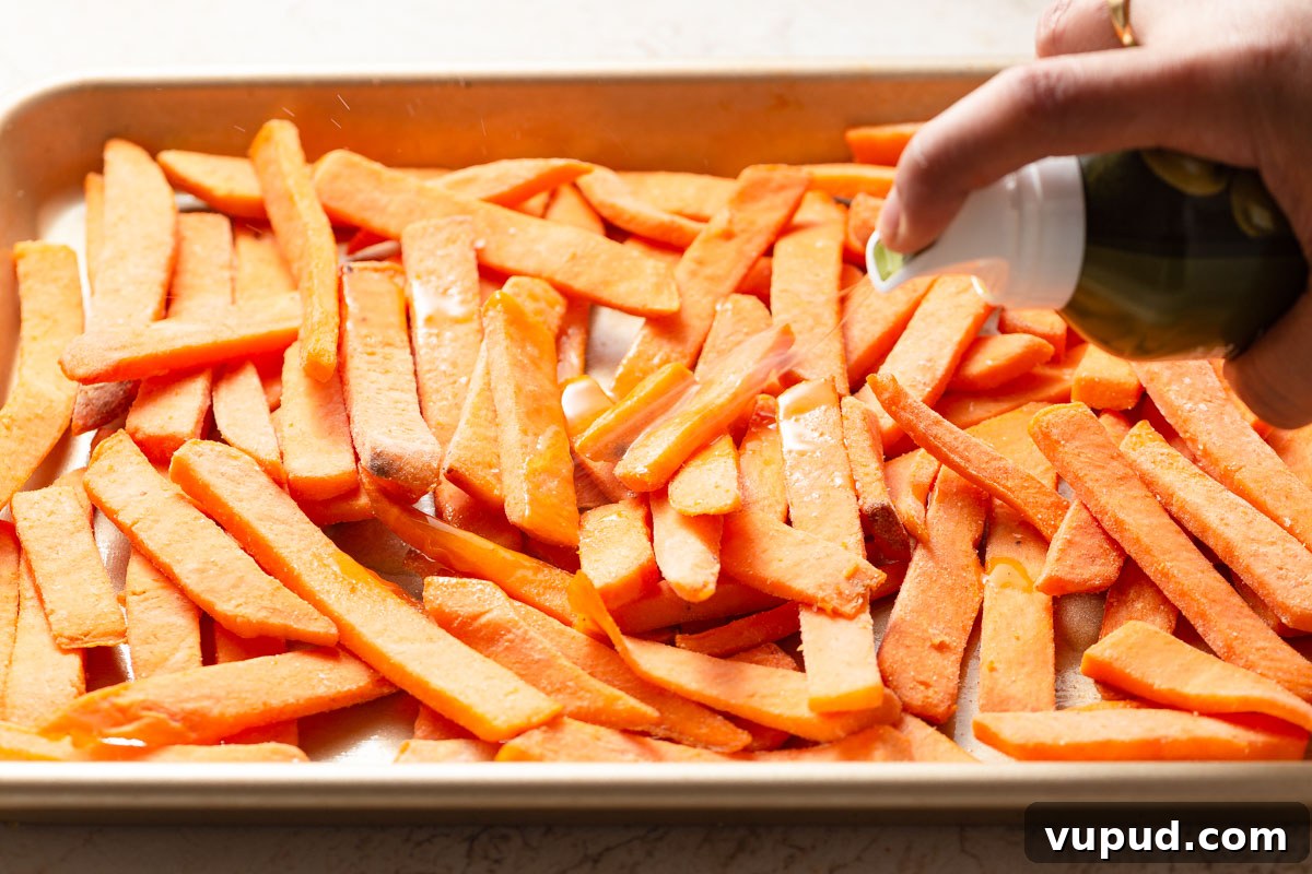 Crispy Air Fryer Frozen Sweet Potato Fries in Minutes 4 spraying the frozen sweet potato fries with an oil mister.