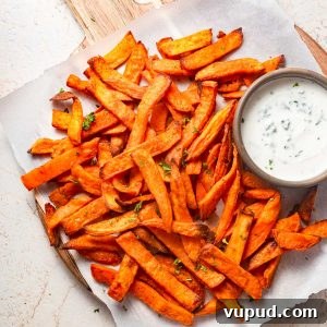 Crispy Air Fryer Frozen Sweet Potato Fries in Minutes 9 air fried frozen sweet potato fries with a dip.