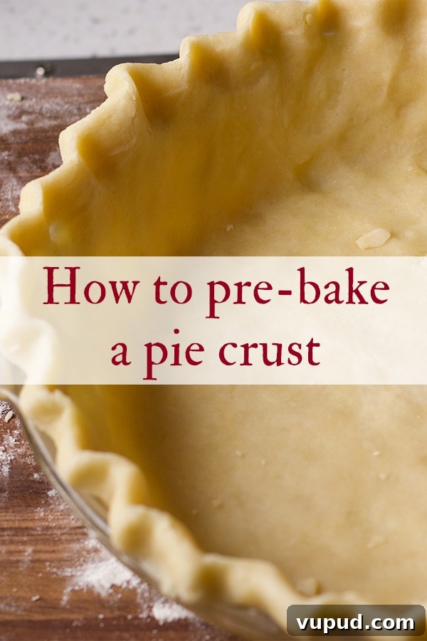 How to Blind-Bake a Pie Crust for a Perfect Fill 2 Pie dough that's been fitted into a glass pie plate and is ready to be baked.