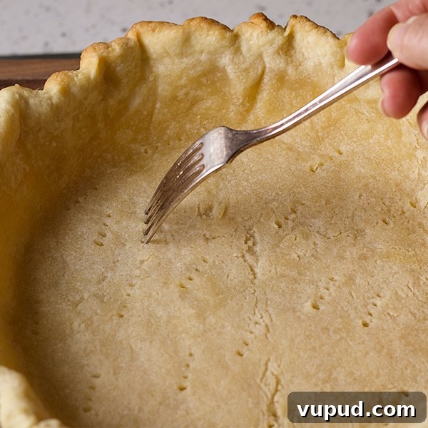 How to Blind-Bake a Pie Crust for a Perfect Fill 10 Poking holes in the bottom of a pie crust before baking.