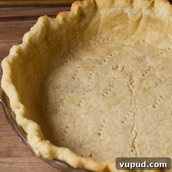 How to Blind-Bake a Pie Crust for a Perfect Fill 11 The bottom pie crust in a pie plate, ready to bake.
