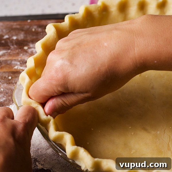 How to Blind-Bake a Pie Crust for a Perfect Fill 7 Crimping the edges of a pie crust before baking.