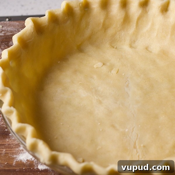 How to Blind-Bake a Pie Crust for a Perfect Fill 8 The bottom pie crust, fitted into a pie plate and ready to bake.