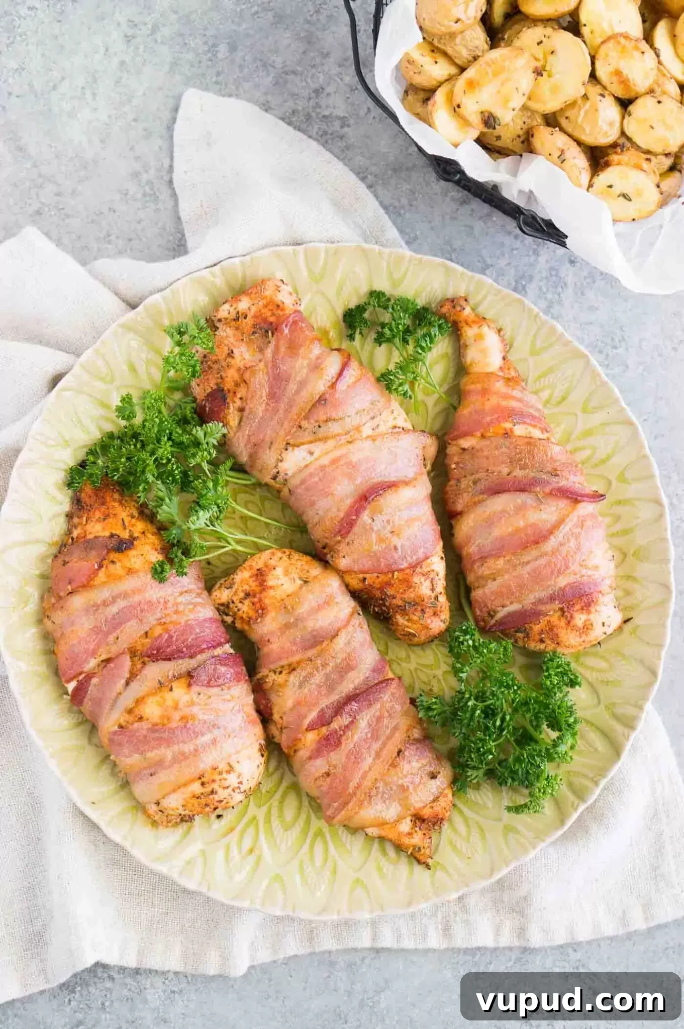Crispy Bacon-Wrapped Chicken Breasts with Garlic Herb Glaze 7 chicken breasts wrapped in bacon on a platter