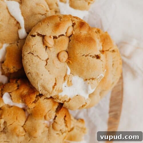 a pile of marshmallow peanut butter cookies on parchment paper.
