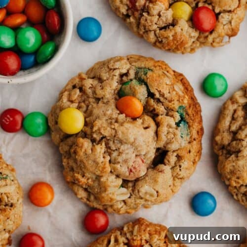 Oatmeal M&M cookies on parchment paper.