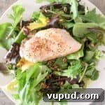 Instant pot chicken breast lightly seasoned and placed on a bed of lettuce.