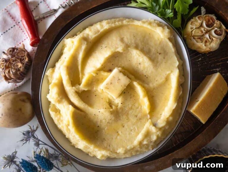 Creamy Garlic Mashed Potatoes Recipe 13 Garlic mashed potatoes in a bowl with butter.
