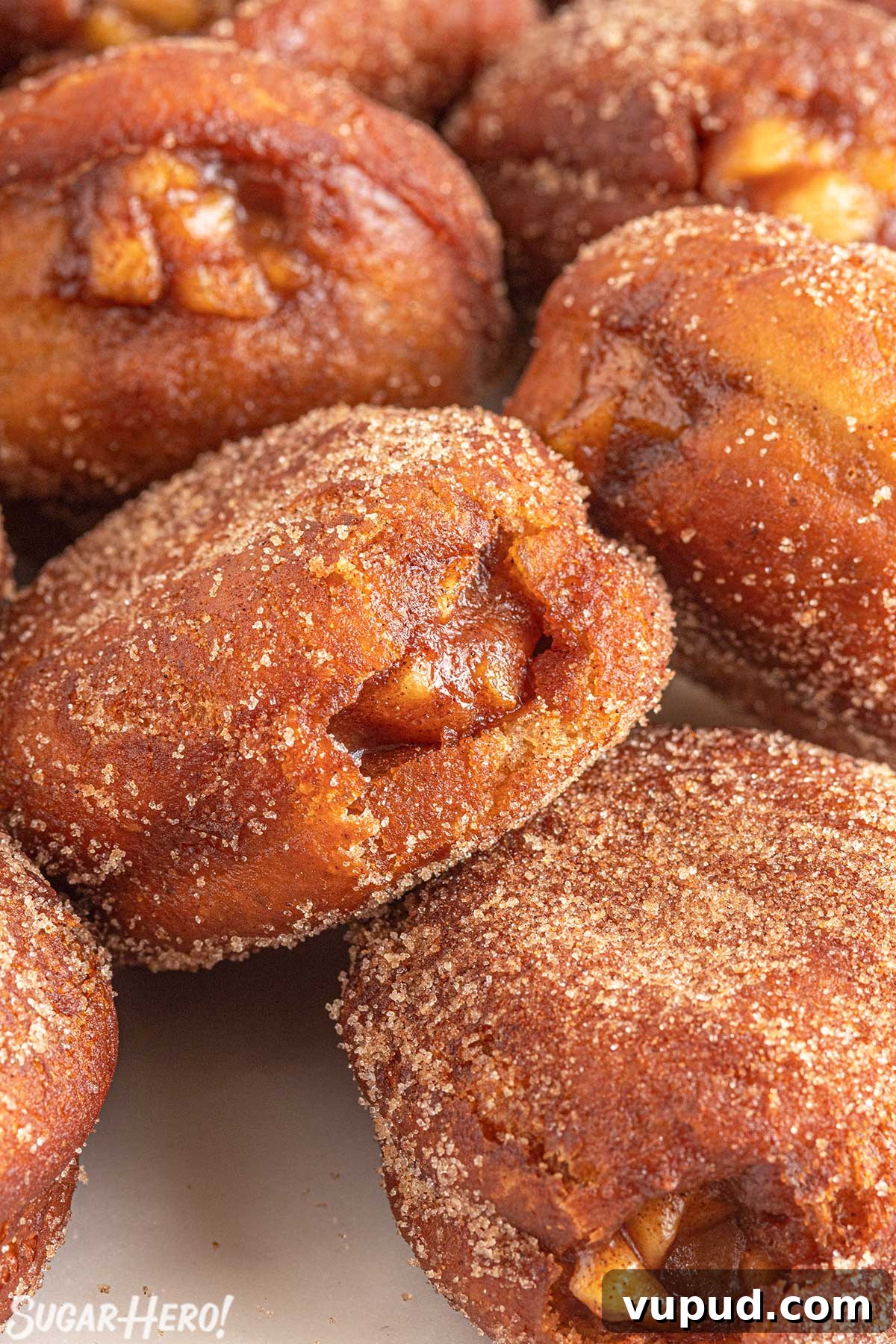 Caramel Apple Donut Recipe: Homemade Baked Apple Donuts with Streusel 2 Close-up of a group of Apple Donuts rolled in cinnamon sugar.