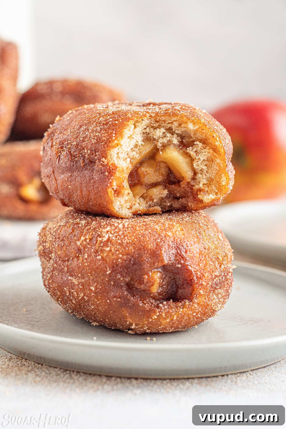 Caramel Apple Donut Recipe: Homemade Baked Apple Donuts with Streusel 3 Two Apple Donuts stacked on top of each other, with a bite taken out of the top donut.