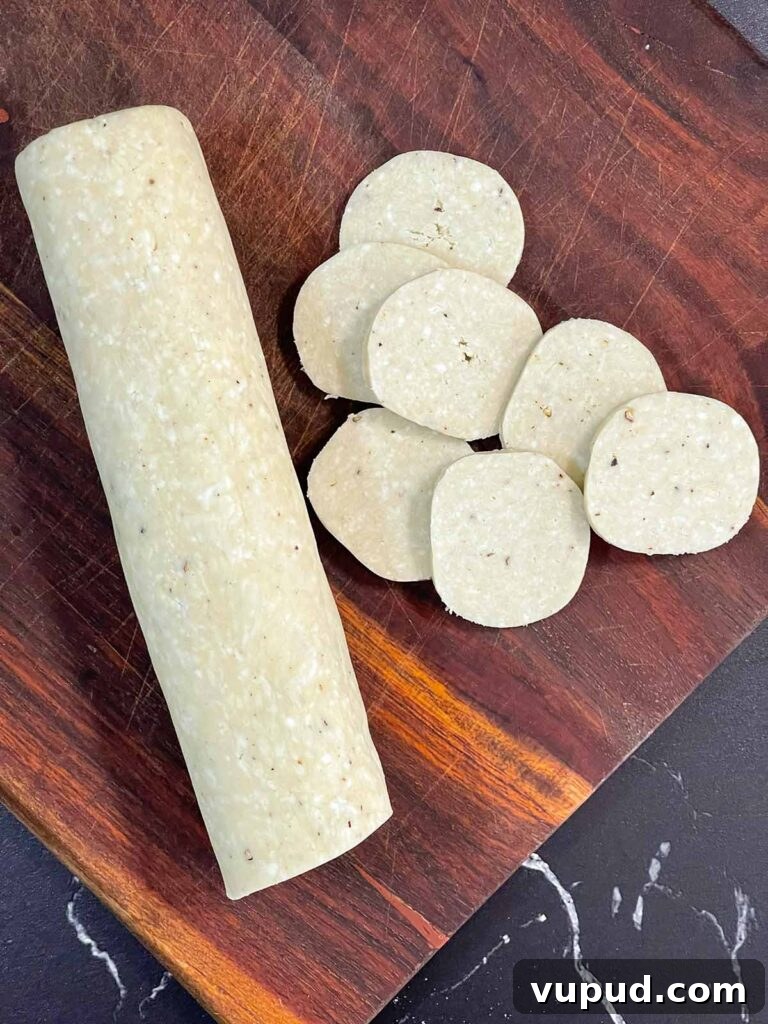 Crispy Blue Cheese Crackers: Homemade Savory Wafers Recipe 8 Sliced blue cheese wafers dough on a wooden board.