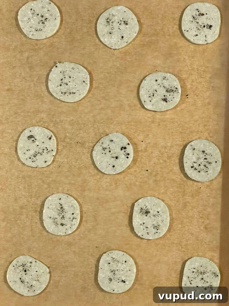 Crispy Blue Cheese Crackers: Homemade Savory Wafers Recipe 9 Raw blue cheese wafers on a parchment paper lined baking sheet.