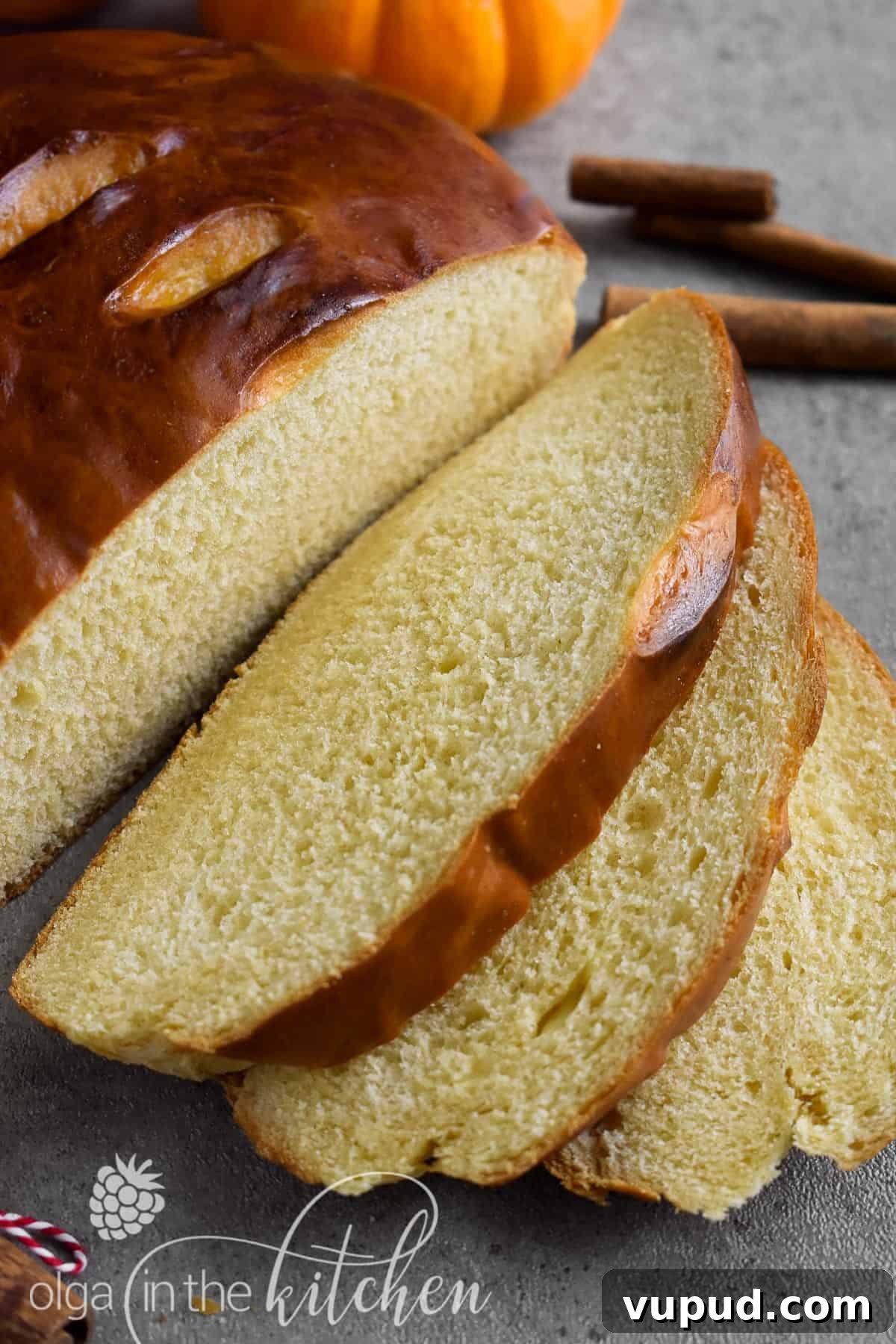 Ukrainian Pumpkin Bread is delicious any time of the year! It has a mild pumpkin flavor from homemade pumpkin puree, a yellow-ish fluffy and tender texture and a shiny dark-brown crust. pumpkin bread in glass round dish