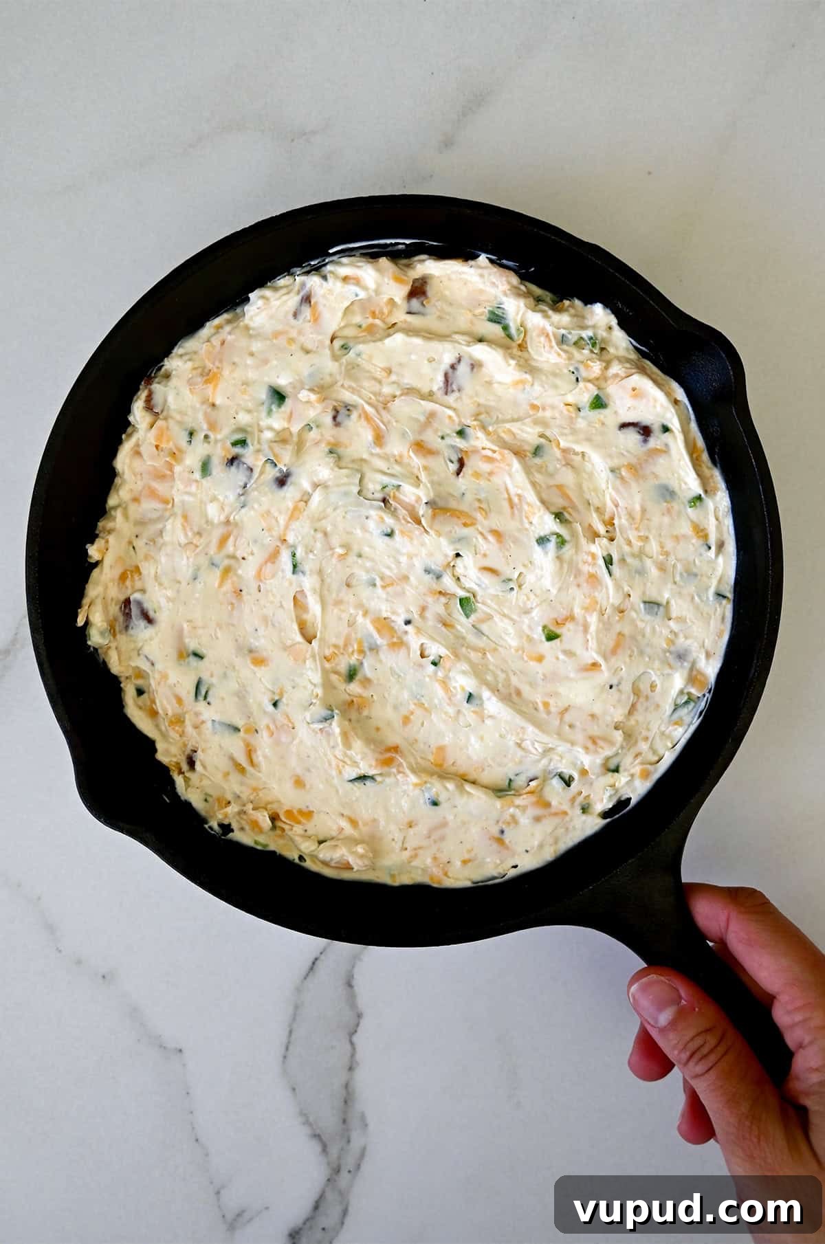 Creamy Jalapeño Popper Dip Recipe for Parties and Game Day 9 Unbaked cream cheese jalapeño and bacon dip in a cast iron skillet.