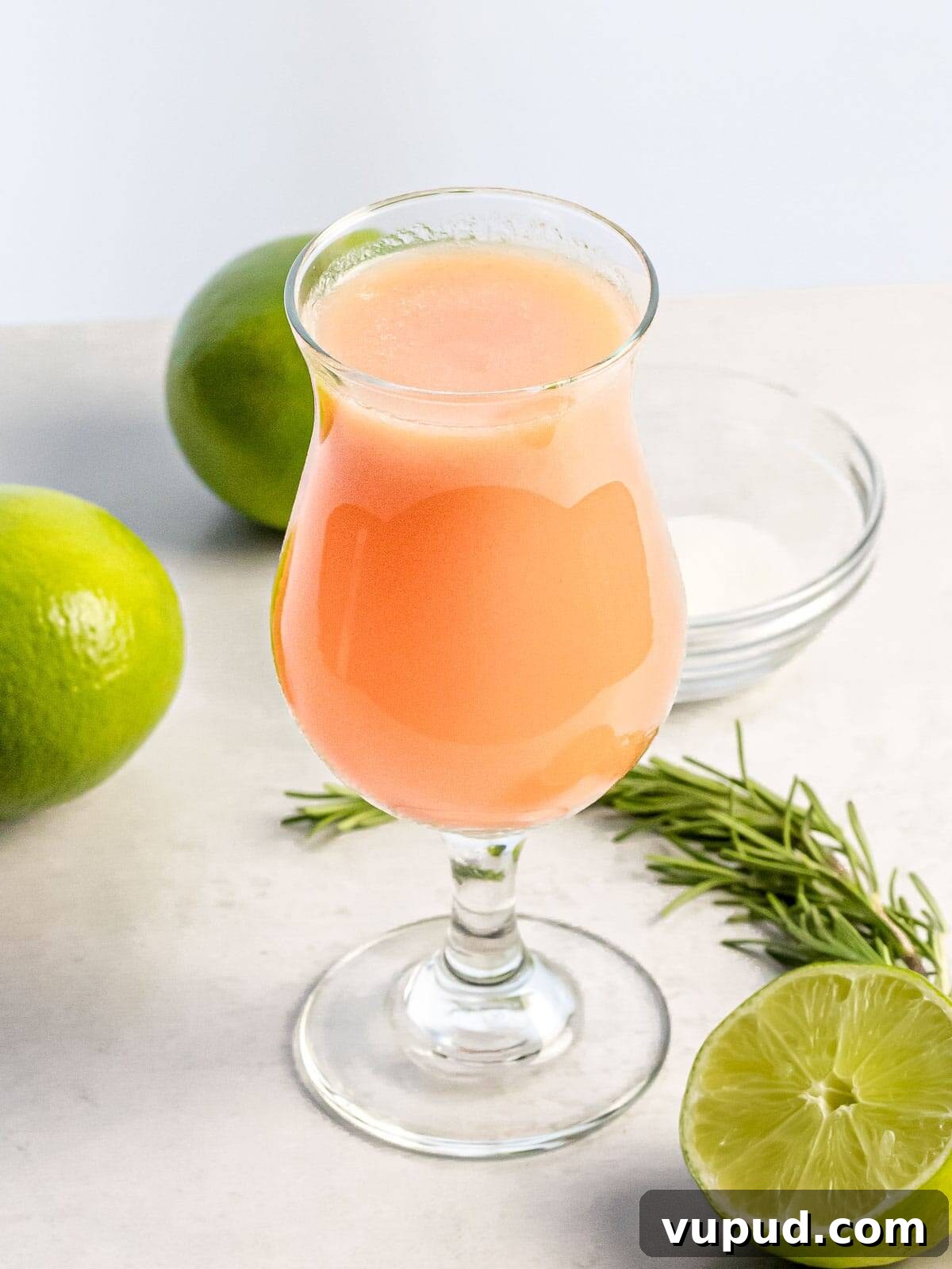 Peach Agua Fresca: Fresh Summer Peach Drink 2 glass of peach agua fresca next to limes and herbs