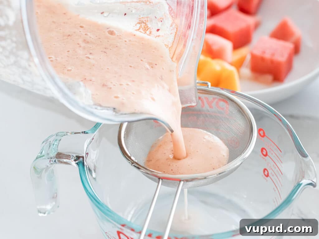 Peach Agua Fresca: Fresh Summer Peach Drink 10 peach juice poured into a strainer