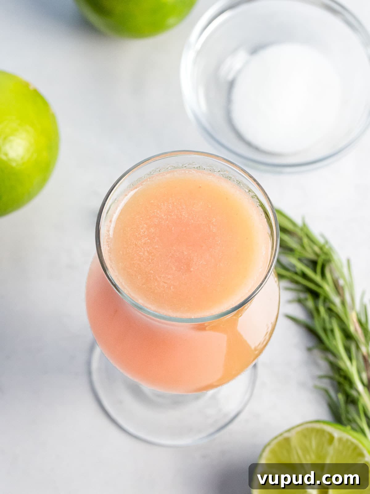 Peach Agua Fresca: Fresh Summer Peach Drink 7 white peach agua fresca in a glass next to lime, sugar, and herbs
