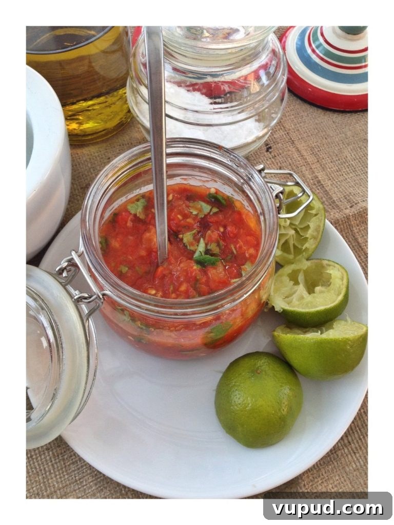 Avocado Green Eggs on Toast: Creamy Brunch Recipe 3 Kilner jar filled with homemade Mexican roast tomato salsa on a plate next to squeezed lime halves