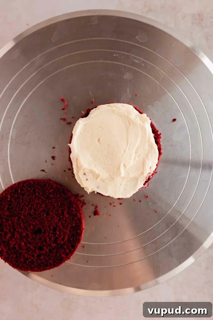 Red Velvet Mini Conversation Heart Cakes — Romantic Valentine Treats 15 Adding frosting to middle of the cake