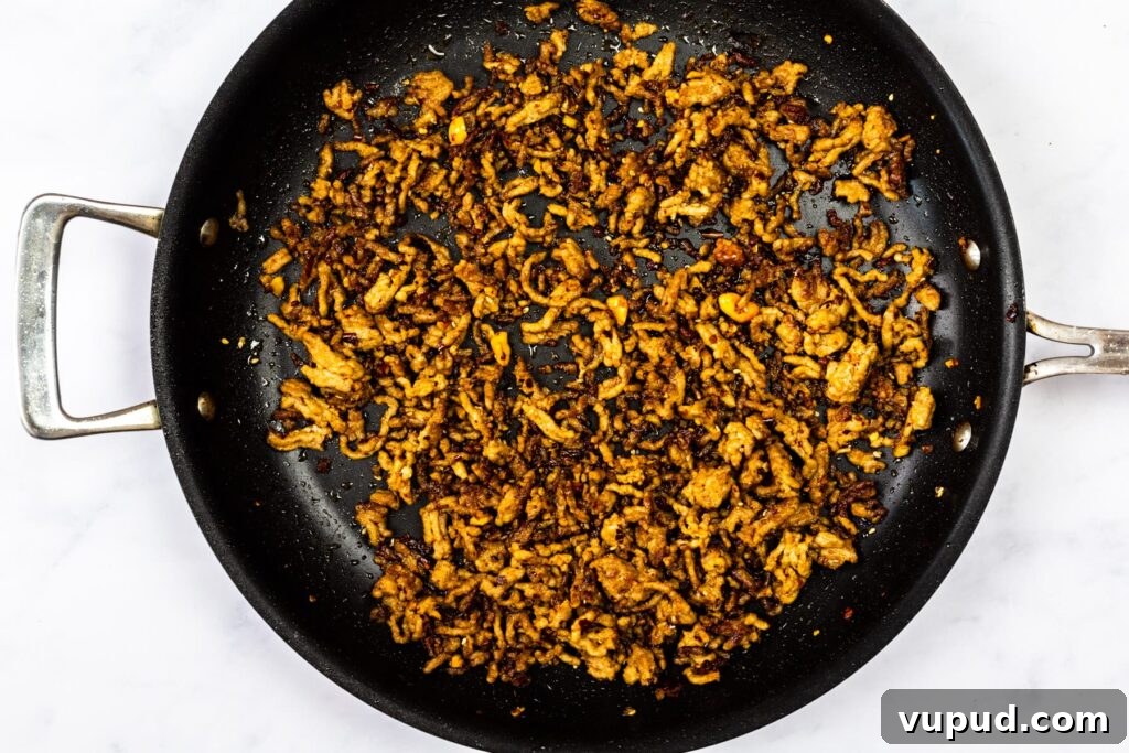 Spicy Sesame Tantanmen Ramen Recipe for Authentic Flavor 6 cooked seasoned pork in a skillet