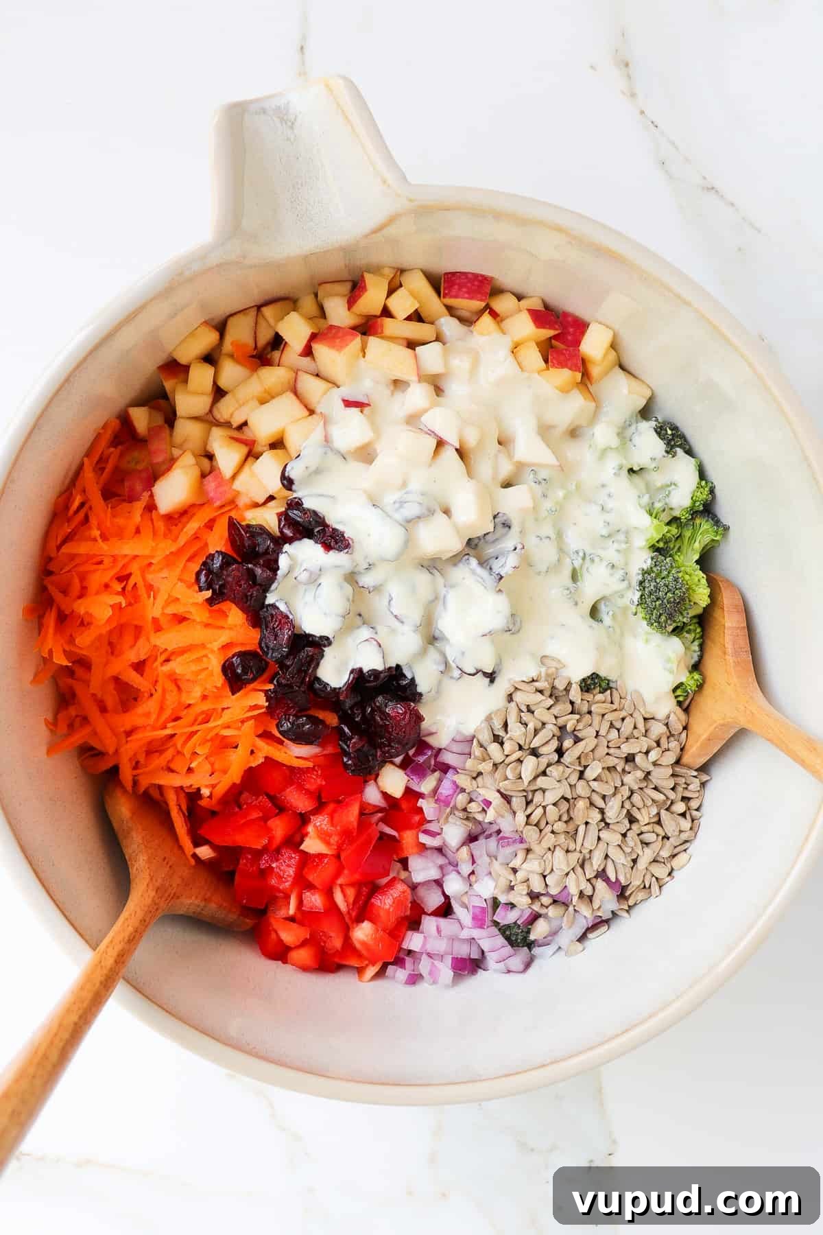 Crispy Broccoli Crunch Salad with Bacon & Tangy Dressing 6 Salad ingredients in a bowl with the dressing poured over.