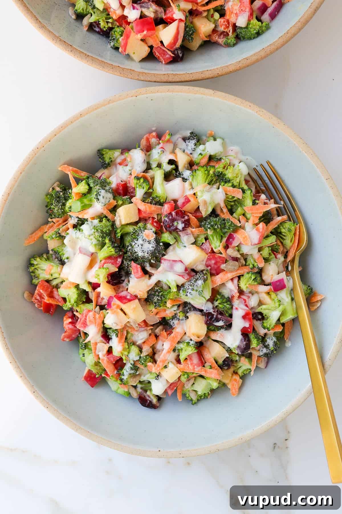 Crispy Broccoli Crunch Salad with Bacon & Tangy Dressing 8 Broccoli salad in a bowl with a fork.