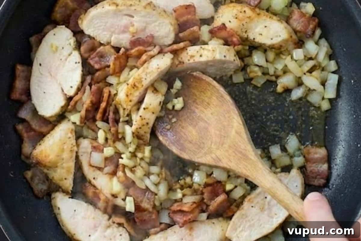 Lighter Chicken Carbonara Recipe: Creamy, Low-Calorie Comfort Meal 6 Heat a non stick frying pan over medium high heat and cook the onion and bacon until the bacon is crisp, about 6 minutes, then add the garlic and chicken and cook until the chicken is cooked through.