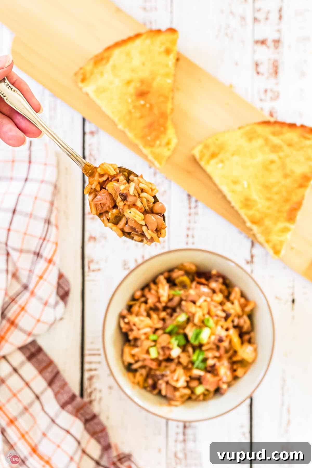 Slow Cooker Hoppin' John Recipe for Flavorful Southern Comfort 11 hand holding a spoon of peas and rice