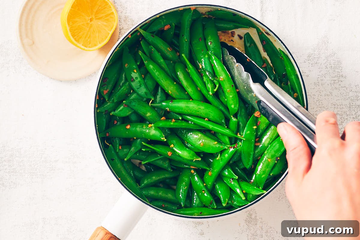 Crisp Snap Pea Salad with Whipped Feta and Lemon Vinaigrette 11 Tossing sugar snap peas in chili garlic oil for Snap Pea Salad.