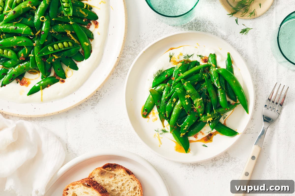 Crisp Snap Pea Salad with Whipped Feta and Lemon Vinaigrette 3 Vegetarian Snap Pea Salad with feta on plates with water glasses.