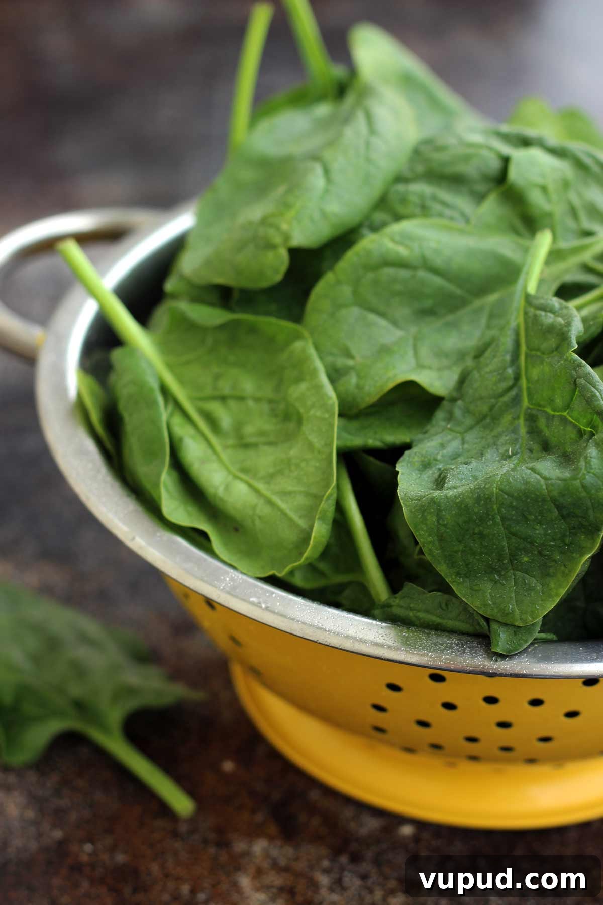 Fresh Spinach in a Yellow Sieve