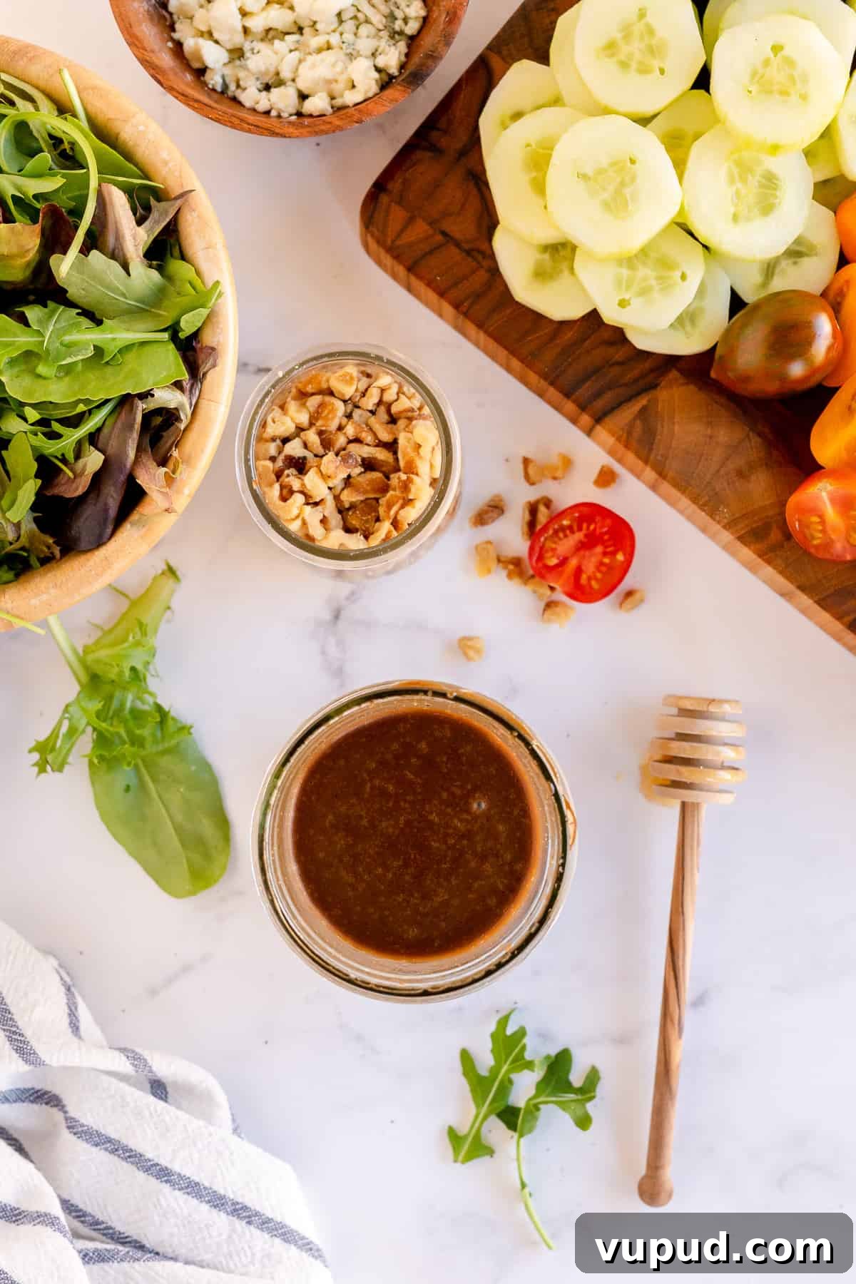 Honey Balsamic Vinaigrette Recipe for Salads and Marinades 6 A jar of vinaigrette surrounded by salad ingredients.