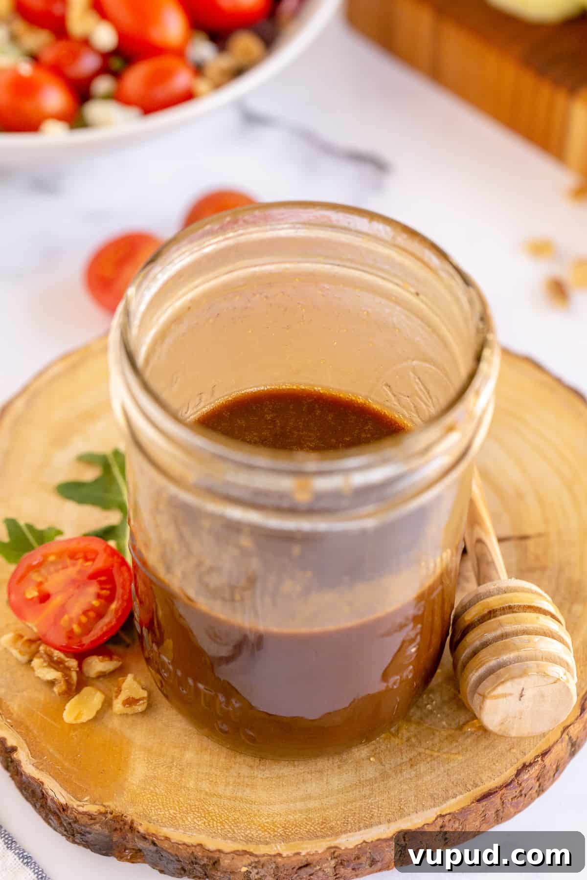 Honey Balsamic Vinaigrette Recipe for Salads and Marinades 7 An open mason jar filled with honey balsamic salad dressing .