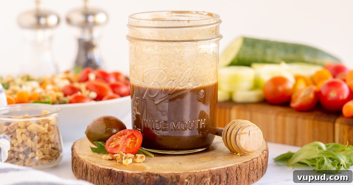 Honey Balsamic Vinaigrette Recipe for Salads and Marinades 8 Honey Balsamic Vinaigrette in a mason jar with vegetables around it.