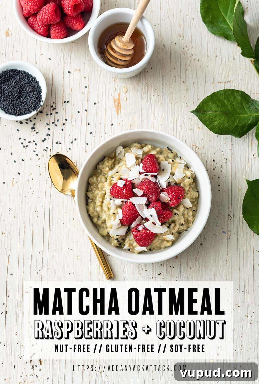 Matcha Oatmeal Meal Prep: Plant-Based Breakfast for Busy Mornings 2 Image of white bowl with matcha oatmeal, topped with raspberries, on a white wood background, with leaves to the side