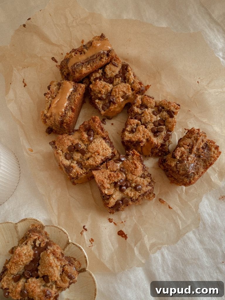 Peanut Butter Chocolate Layer Bars (Grain-Free Recipe) 3 Grain Free Peanut Butter Chocolate Cookie Layer Bars on parchment paper