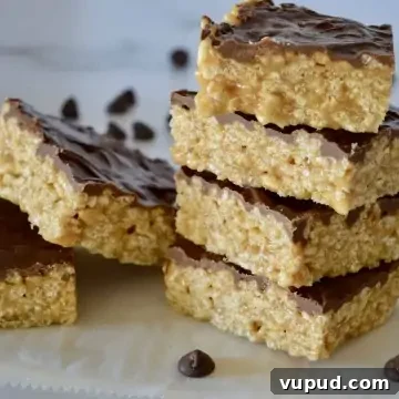 Caramel Peanut Butter Krispie Bars Without Marshmallows 5 Caramel Peanut Butter Krispies staked on a white countertop.