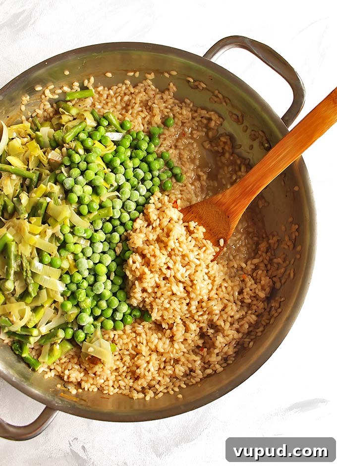Spring Brown Rice Risotto with Fresh Herbs and Asparagus 4 Brown Rice Spring Risotto - Risotto made with brown rice for added health benefits and more texture. This risotto is packed with spring veggies like leeks, asparagus, and peas! This recipe makes a great side dish or add shrimp for a complete meal! Vegetarian/Gluten Free | robustrecipes.com