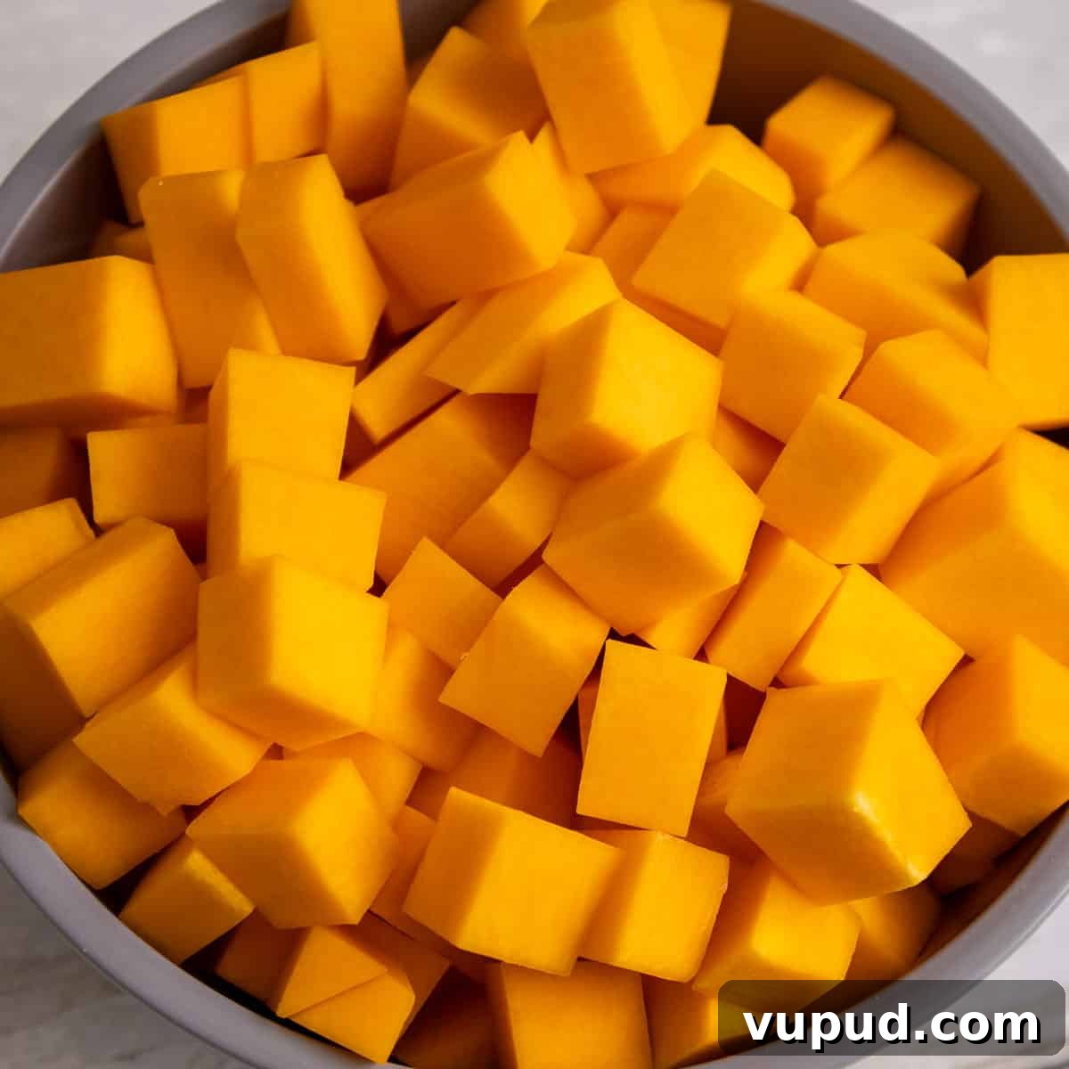 Crispy Air Fryer Butternut Squash Recipe: Quick Roasted Cubes 4 Cubed butternut squash in a mixing bowl.