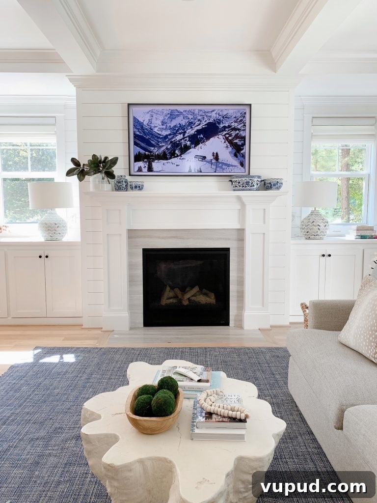 What Size Samsung The Frame TV Should You Mount Above a Fireplace? 9 Samsung Frame tv 55" above a fireplace mantel in a living room
