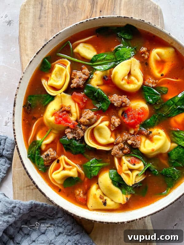 Creamy Sausage and Tortellini Soup Recipe for Cozy Nights 7 Bowl of tortellini soup with grated Parmesan