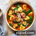 Creamy Sausage and Tortellini Soup Recipe for Cozy Nights 8 Close up of Tortellini soup with sausage in a white bowl.