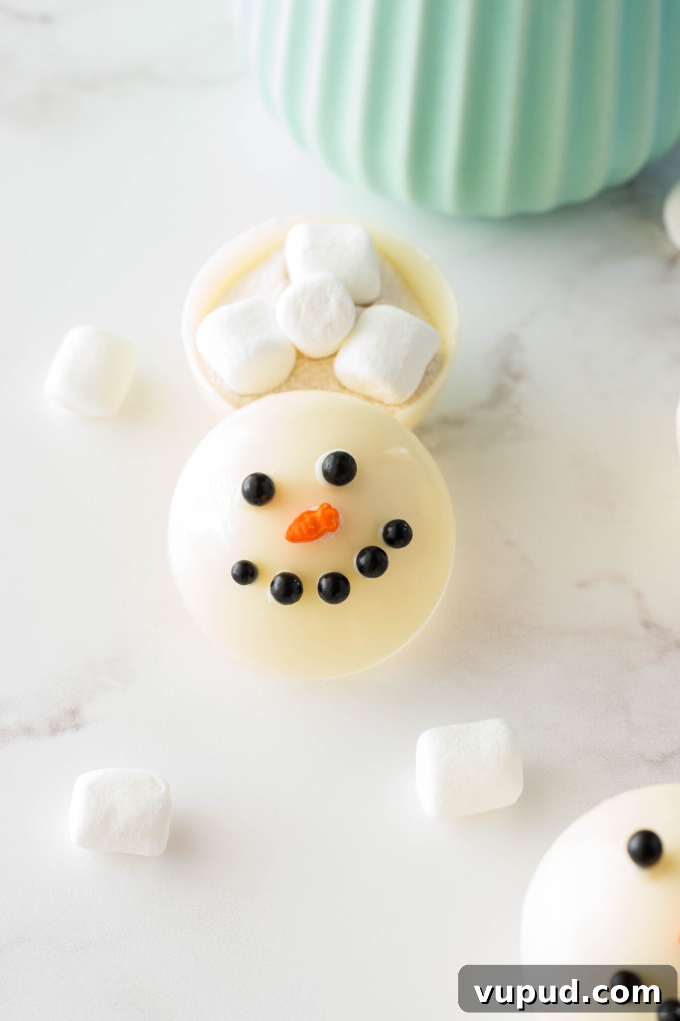 Snowman Hot Chocolate Bombs Recipe for Cozy Winter Drinks 3 snowman hot cocoa bomb cut in half with hot cocoa ingredients inside