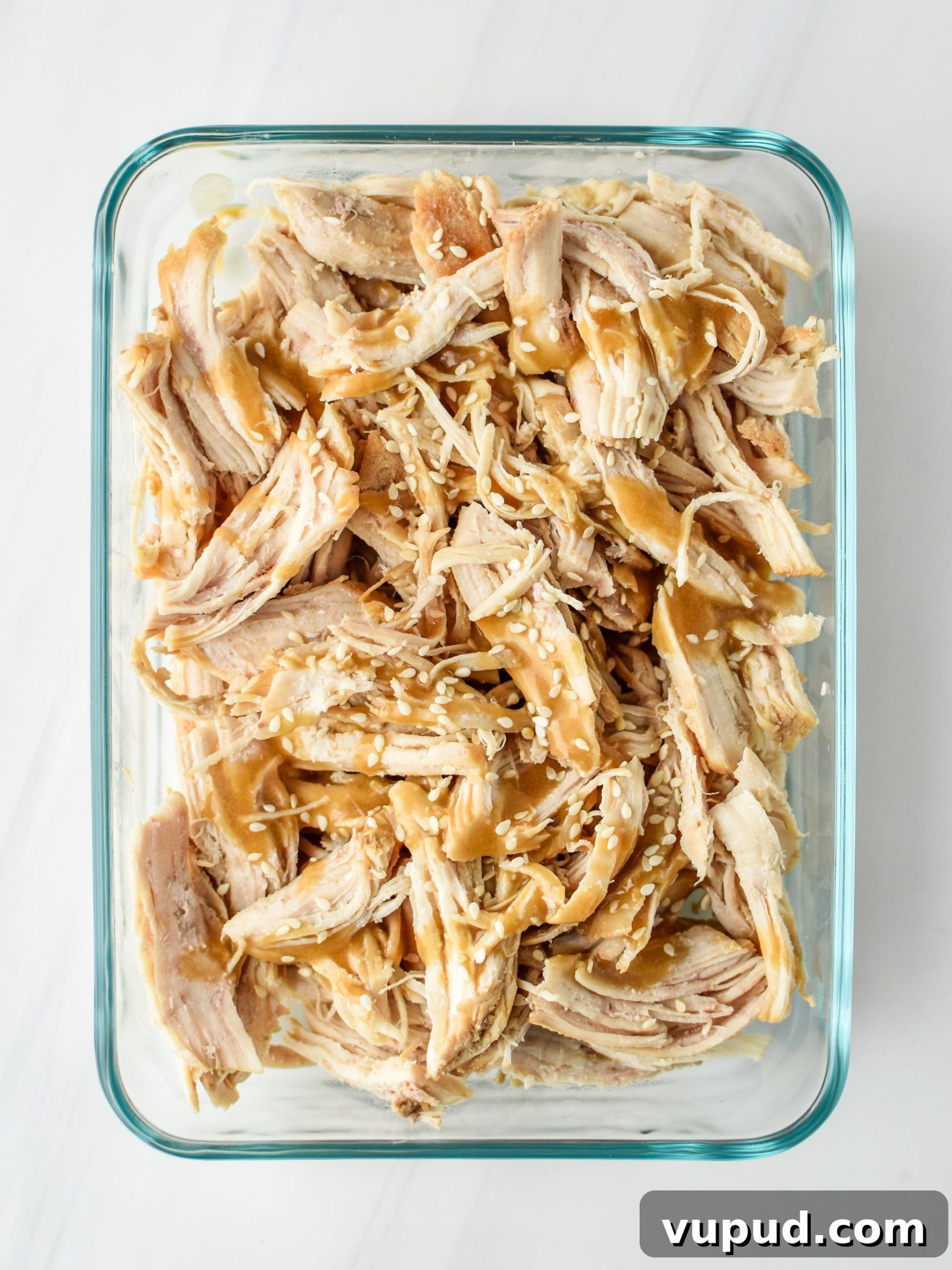 Instant Pot Sesame Shredded Chicken Recipe 7 Meal prepped sesame shredded chicken with sauce and sesame seeds on top